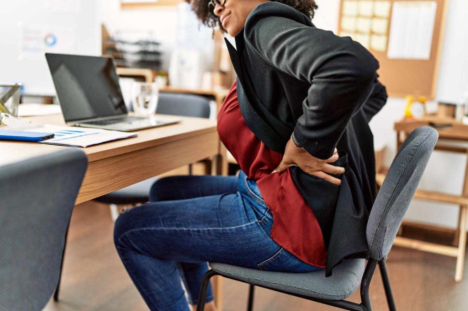 A woman at work suffering from back pain