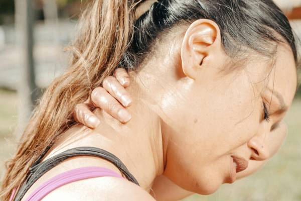 A woman suffering from neck pain