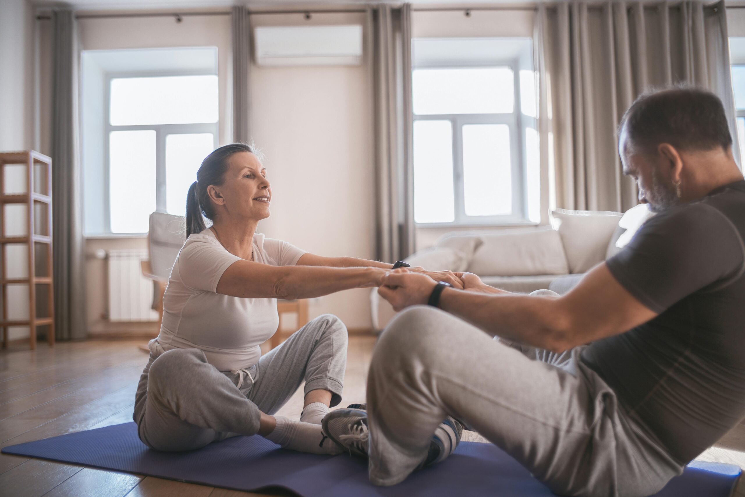 A husband helping her wife with home care physiotherapy