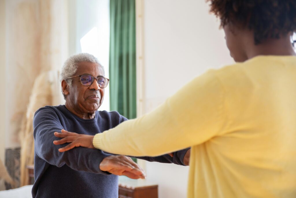 A physio helping a stroke patient regain his mobility