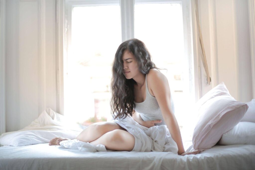 A woman holding her stomach indicating pain