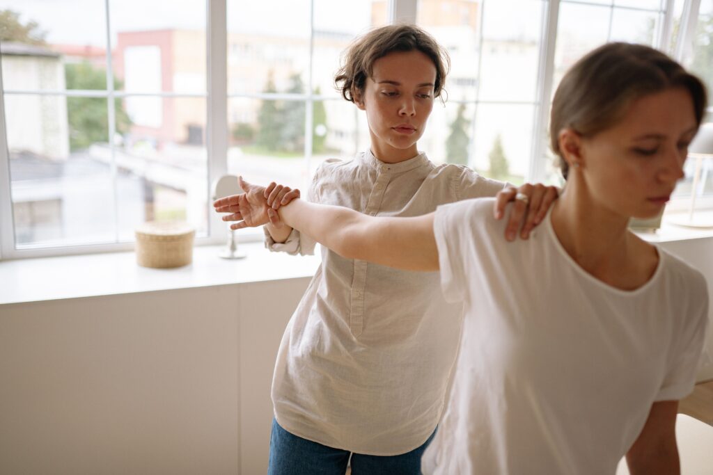 A physiotherapist helping the patient for back pain