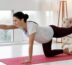 A woman practicing yoga in her cozy living room, focusing on her balance and mindfulness.