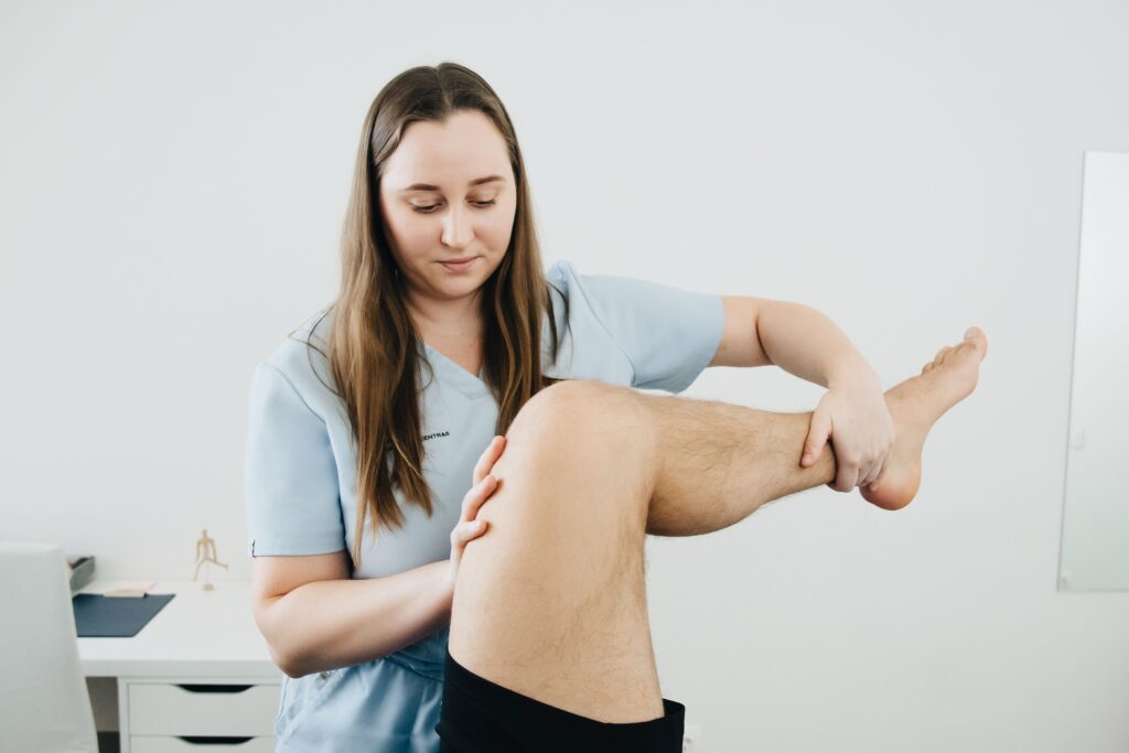 A physiotherapist treating the patient by following the pain management programme
