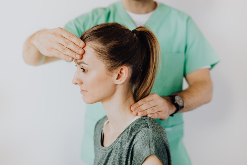 A physiotherapist treating the neck of a patient